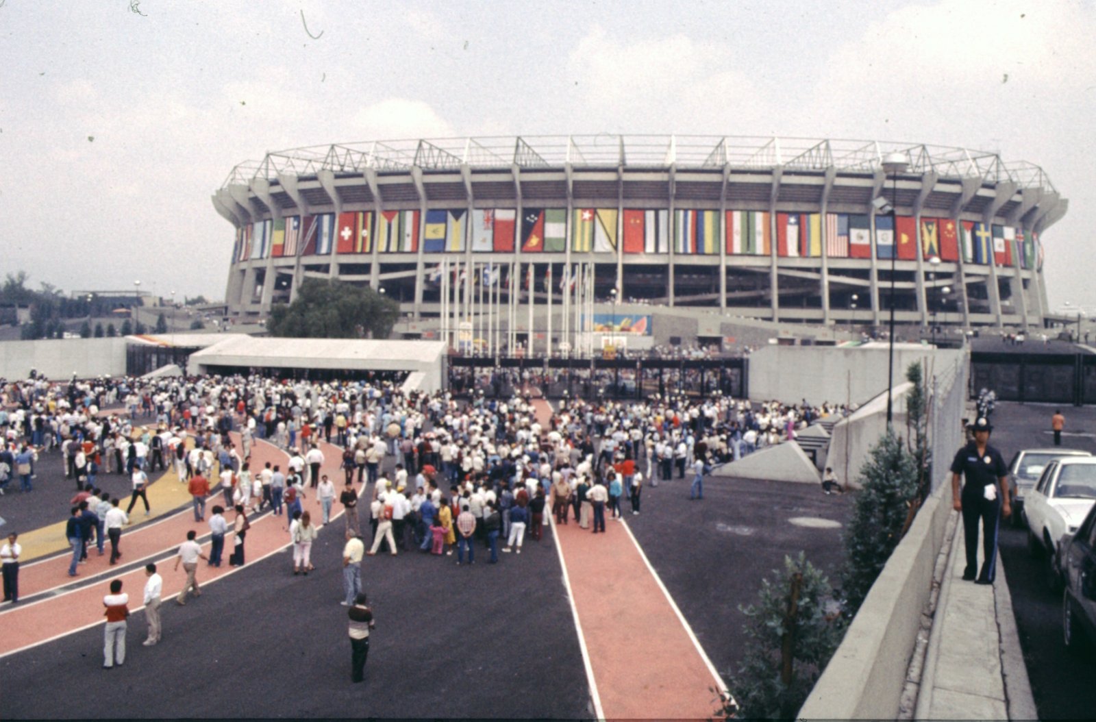 Fans in front of Estadio Azteca in Mexico City, decorated with national flags during the 1986 World Cup