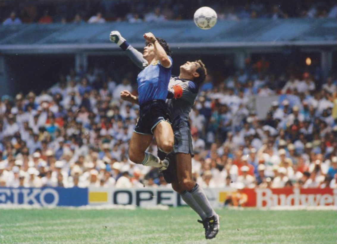 Maradona rises next to goalkeeper Peter Shilton and punches the ball into the net for the Hand of God at the Estadio Azteca, 1986