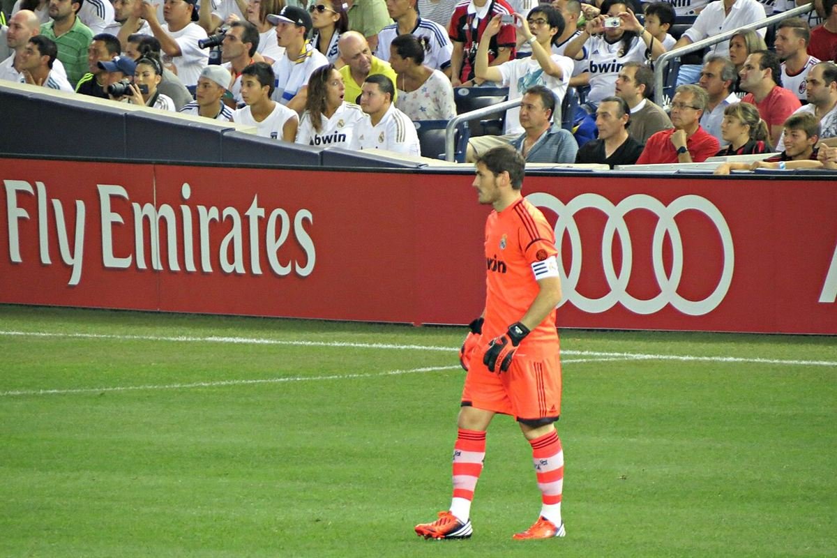 Iker Casillas in Real Madrid's orange goalkeeper kit and captain's armband in August 2012