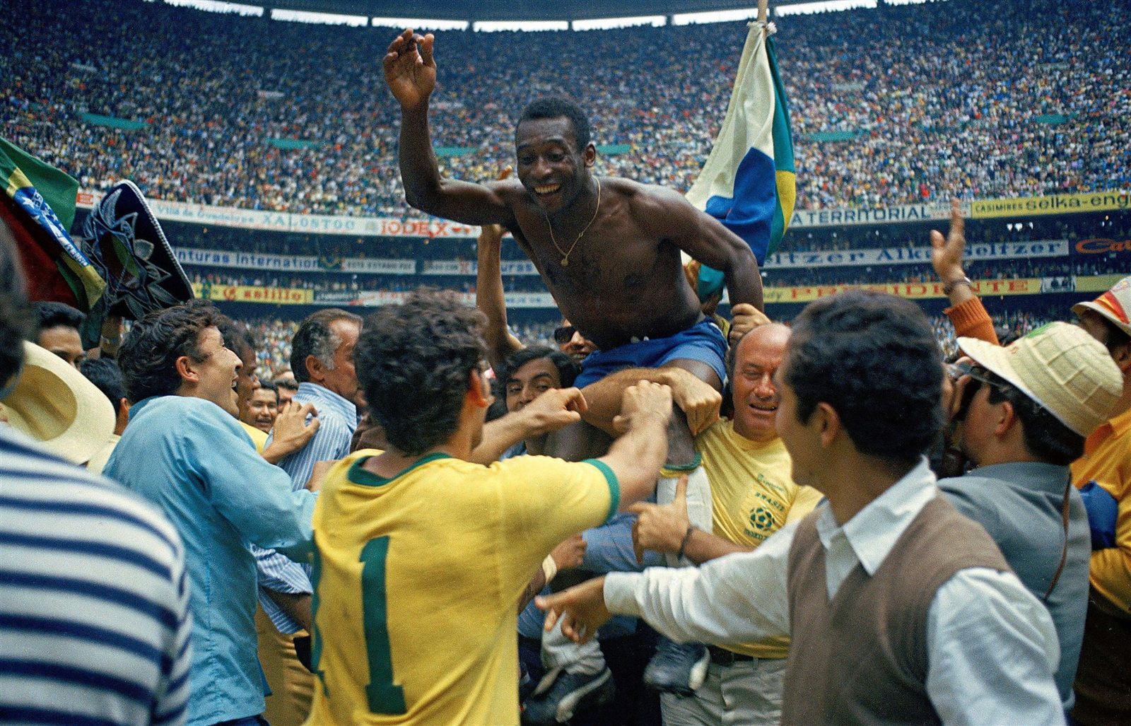 Pelé is carried on the shoulders of the crowd at Estadio Azteca after Brazil's third World Cup title in 1970