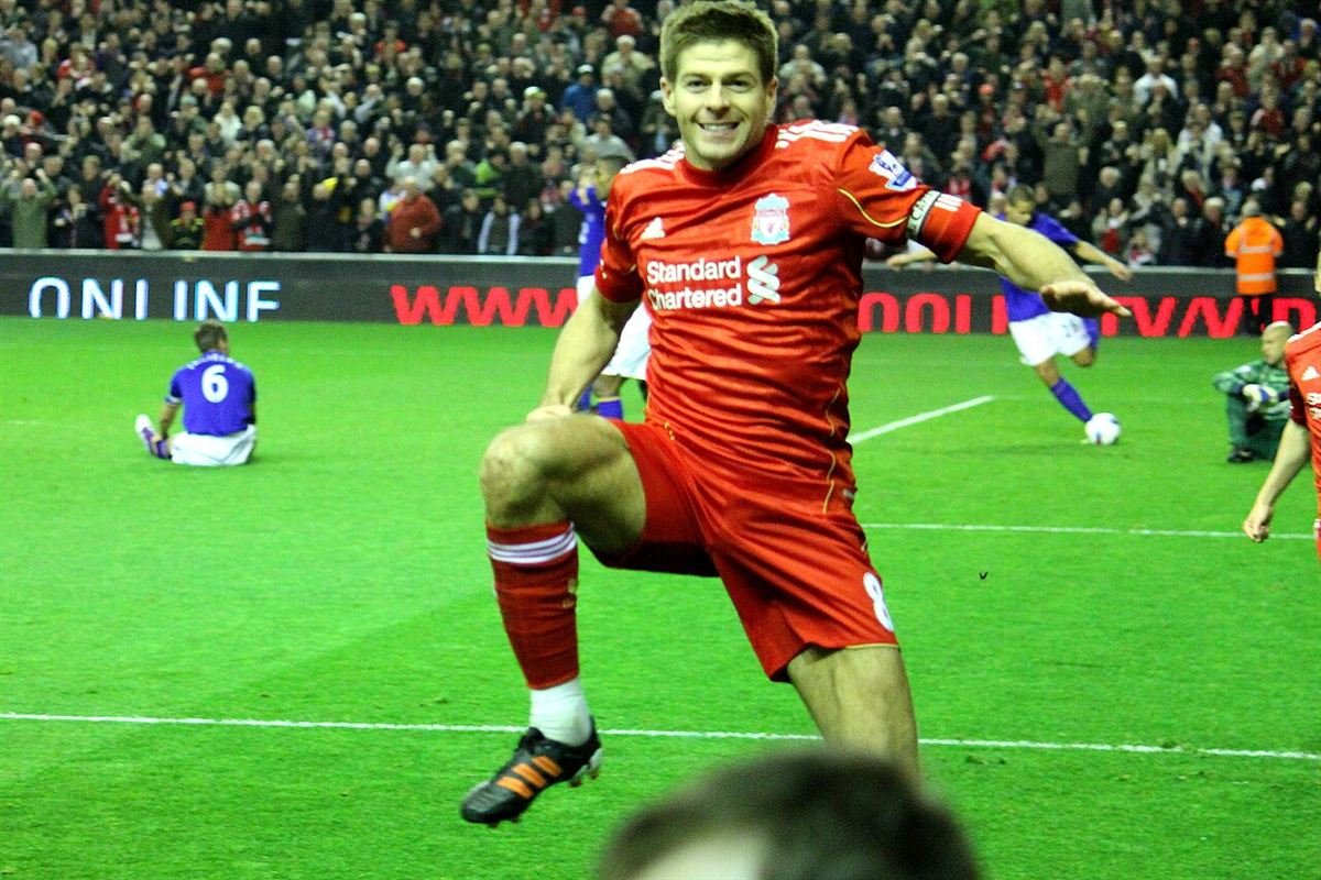 Steven Gerrard in Liverpool's red number 8 shirt and captain's armband celebrating a goal in a Merseyside derby in March 2012
